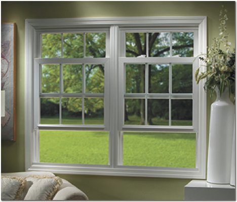 A living room with a large window looking out to a lush green field