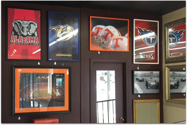 Alabama and tennessee football posters hang on a wall