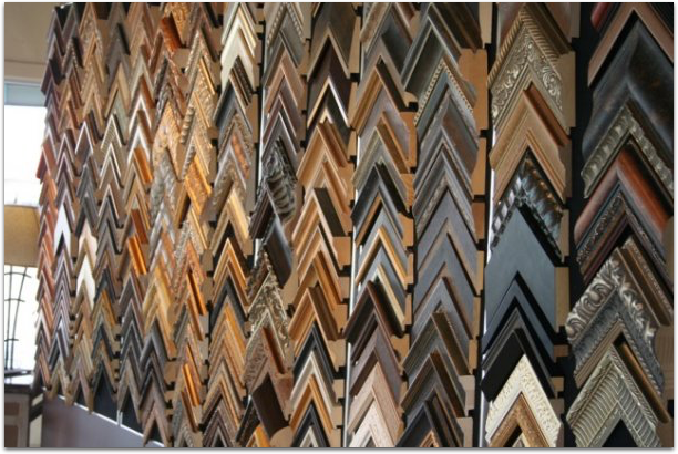 A wall filled with many different types of picture frames