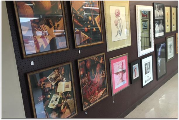 A row of framed pictures on a wall with one that says ' a ' on it