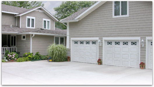 A house with three garage doors and a driveway