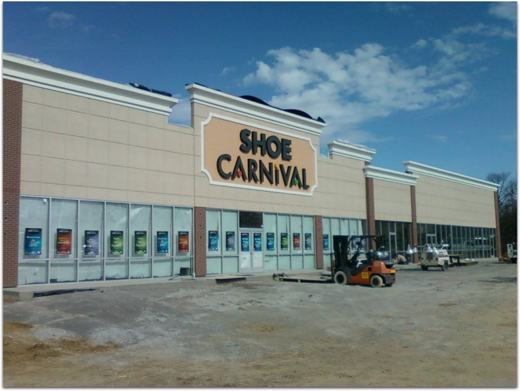 A shoe carnival store with a forklift in front of it