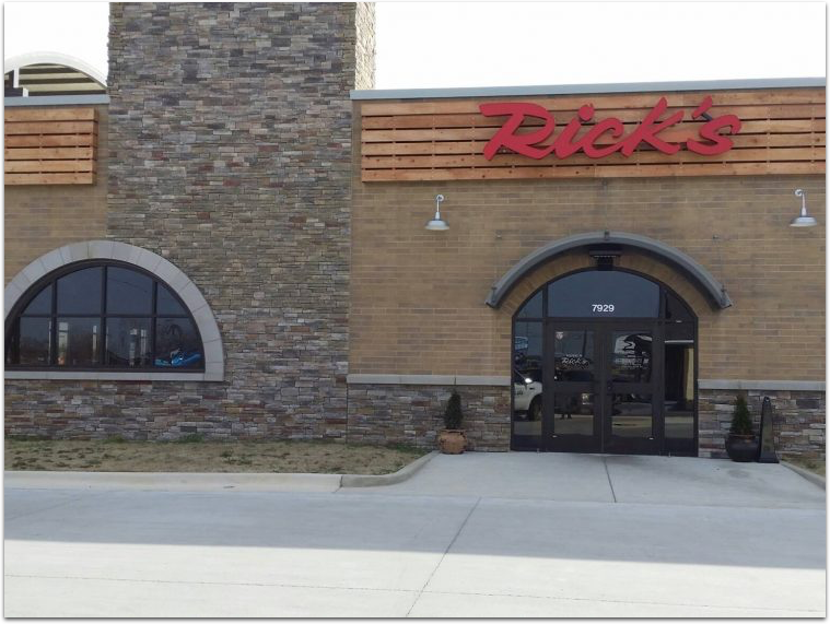 Rick 's restaurant has a stone facade and a red sign