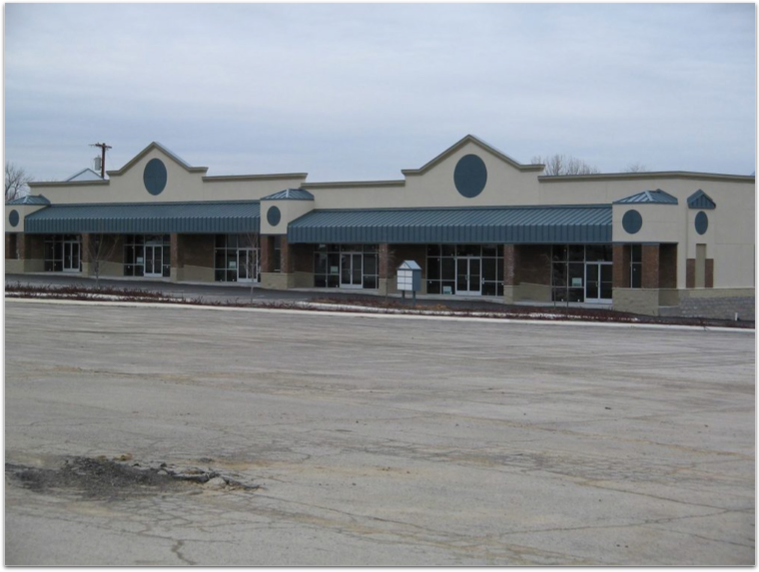 An empty parking lot in front of a building