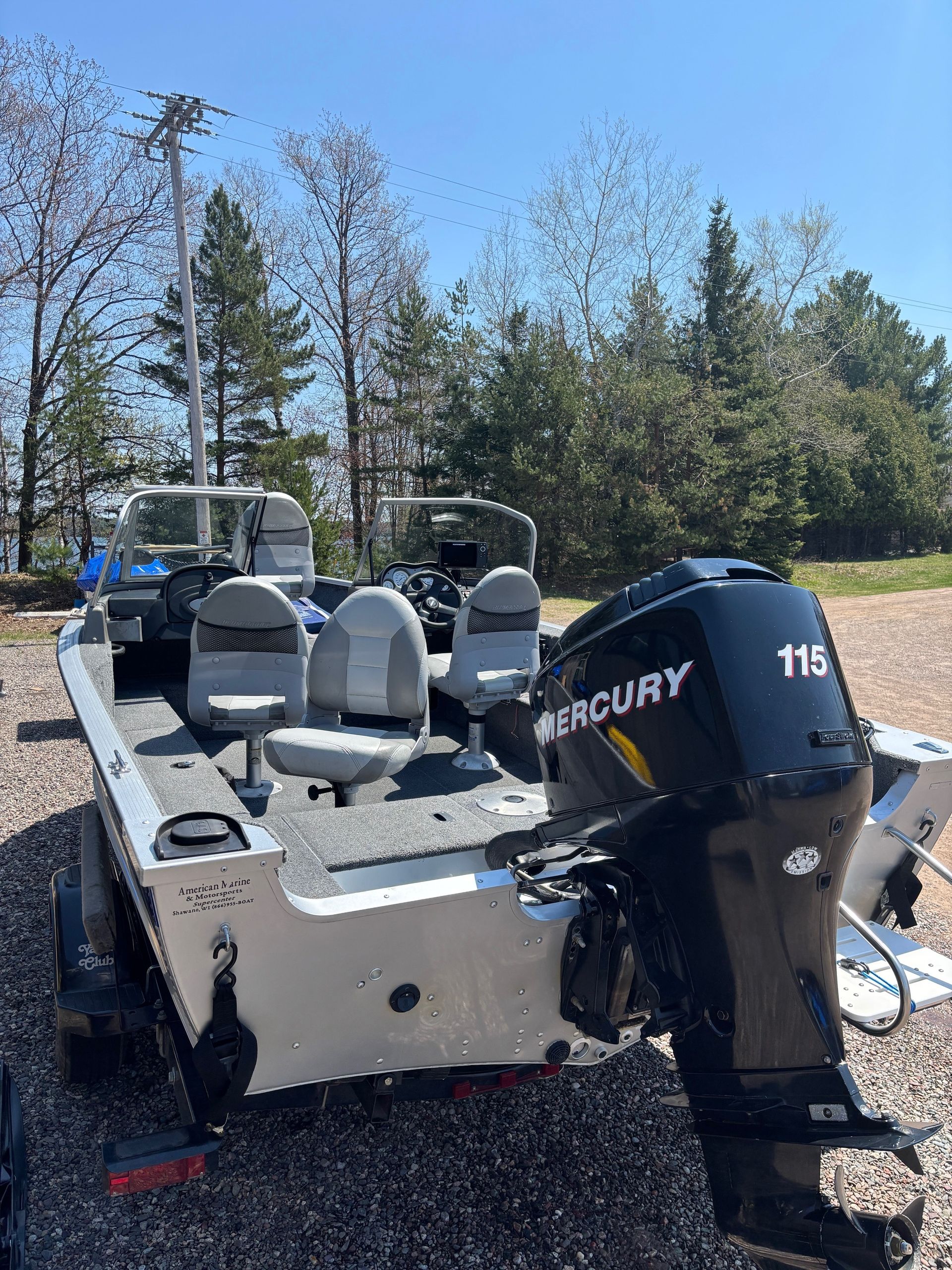 A fishing boat with a 60 hp engine is parked on the side of the road