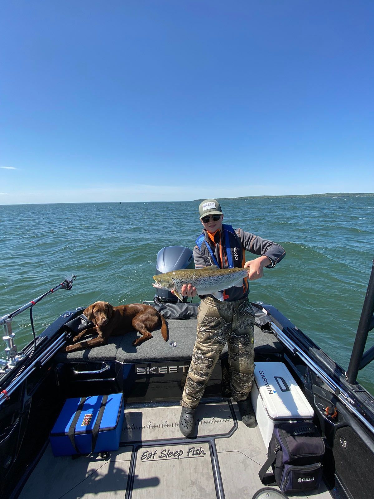 A boy holding a large fish