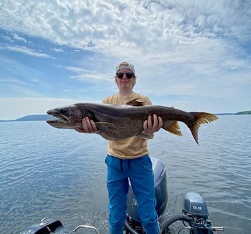 Boy holding a huge fish