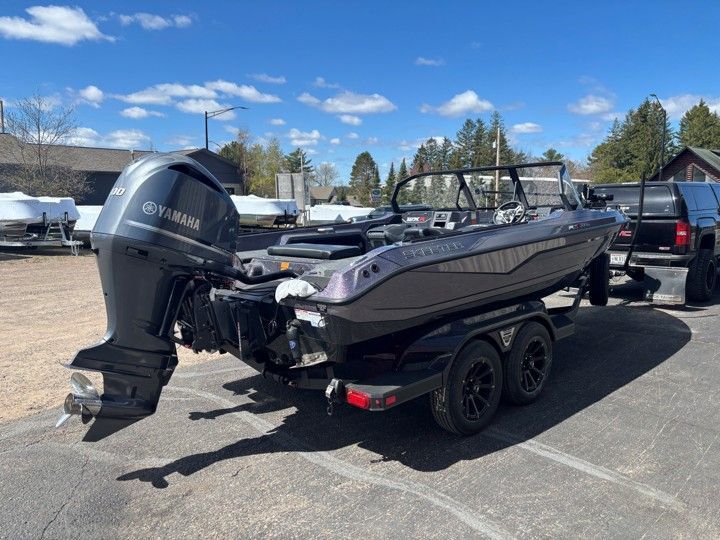 Gray Yamaha fishing boat on a trailer in a parking lot under a blue sky
