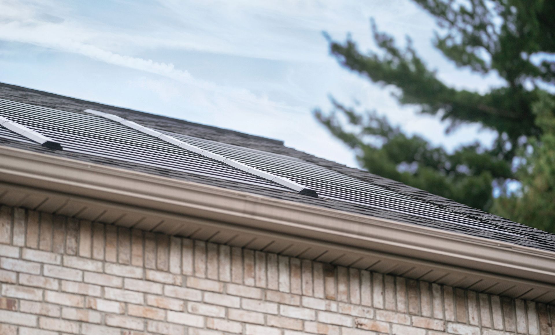 A brick house with solar panels on the roof.