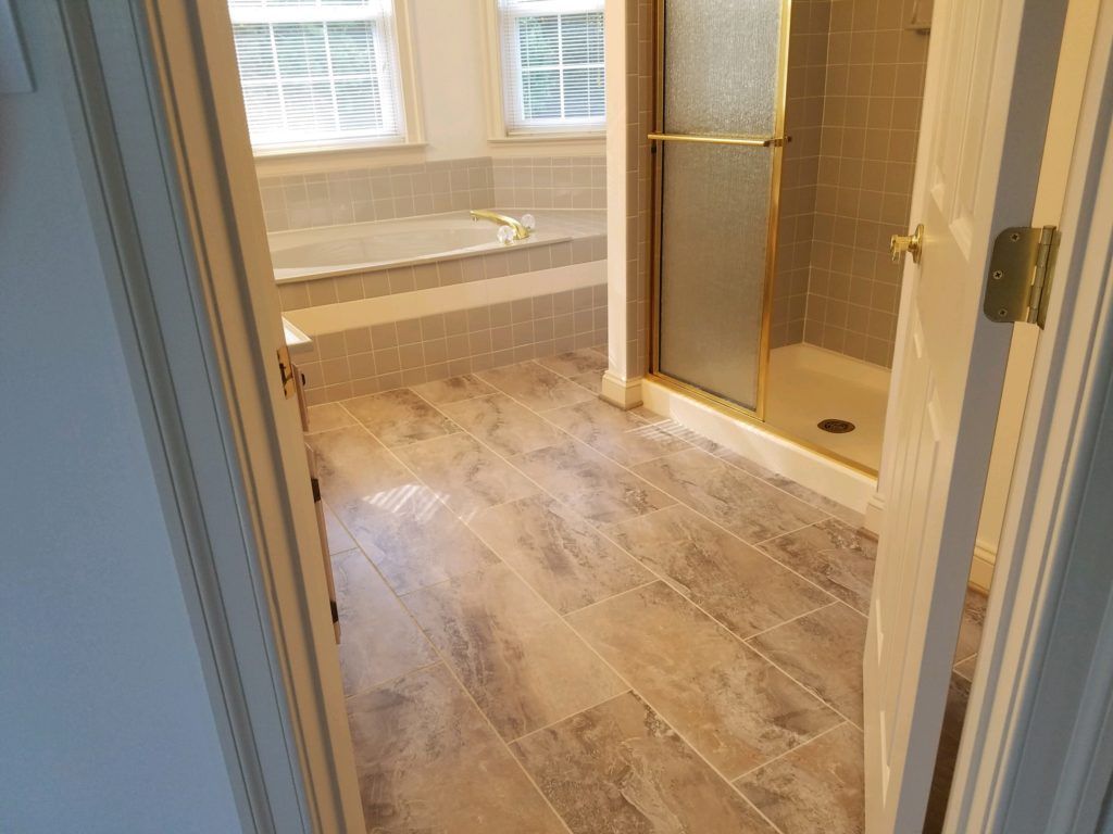 a bathroom with a walk in shower and a bathtub