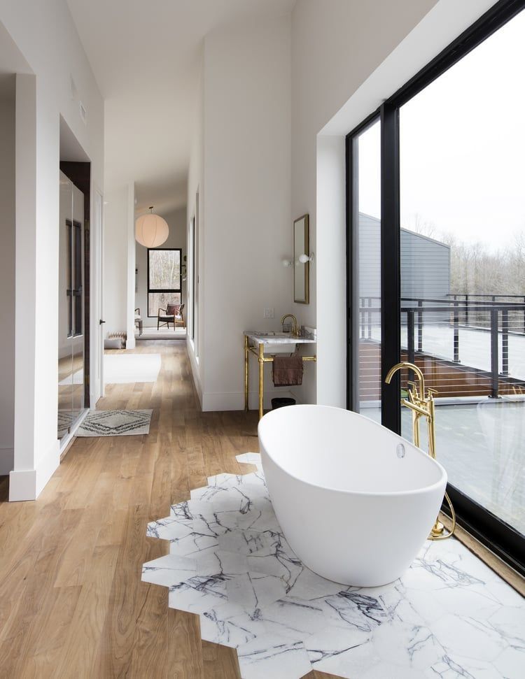 a bathroom with a bathtub and a large window