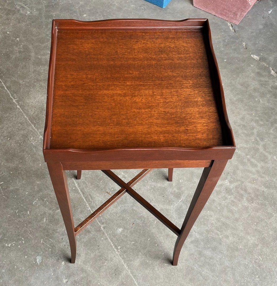 a small wooden table with a tray on top