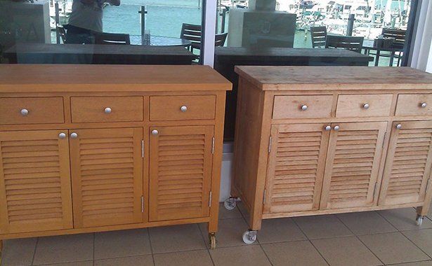 two wooden cabinets are sitting next to each other on a tiled floor