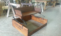 a wooden box with a saw in it is sitting on the floor in a room