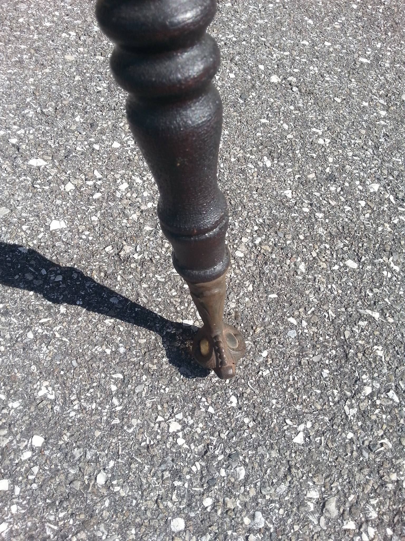 a close-up of a wooden table leg on a gravel road