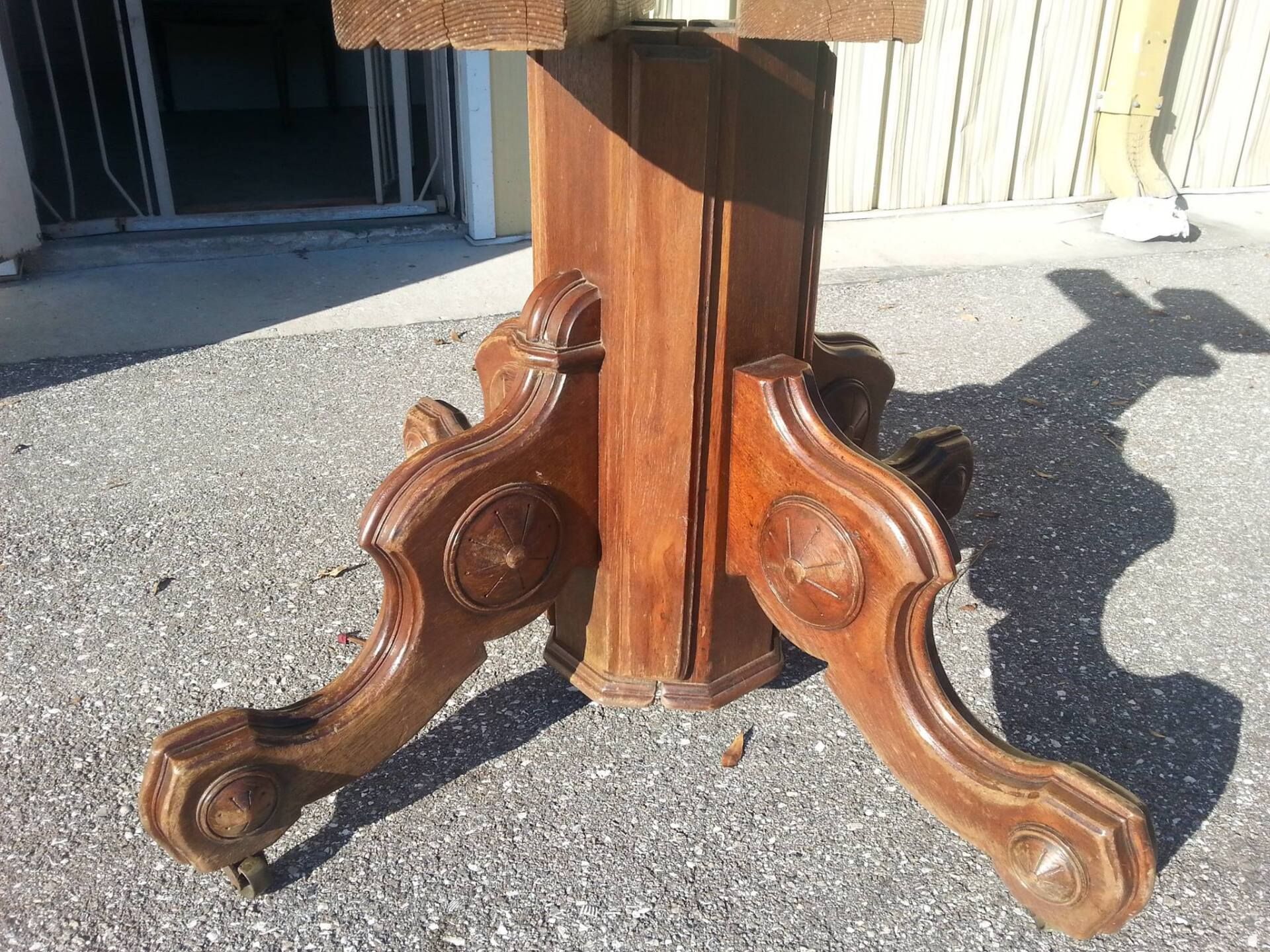 a wooden table is sitting on a gravel road