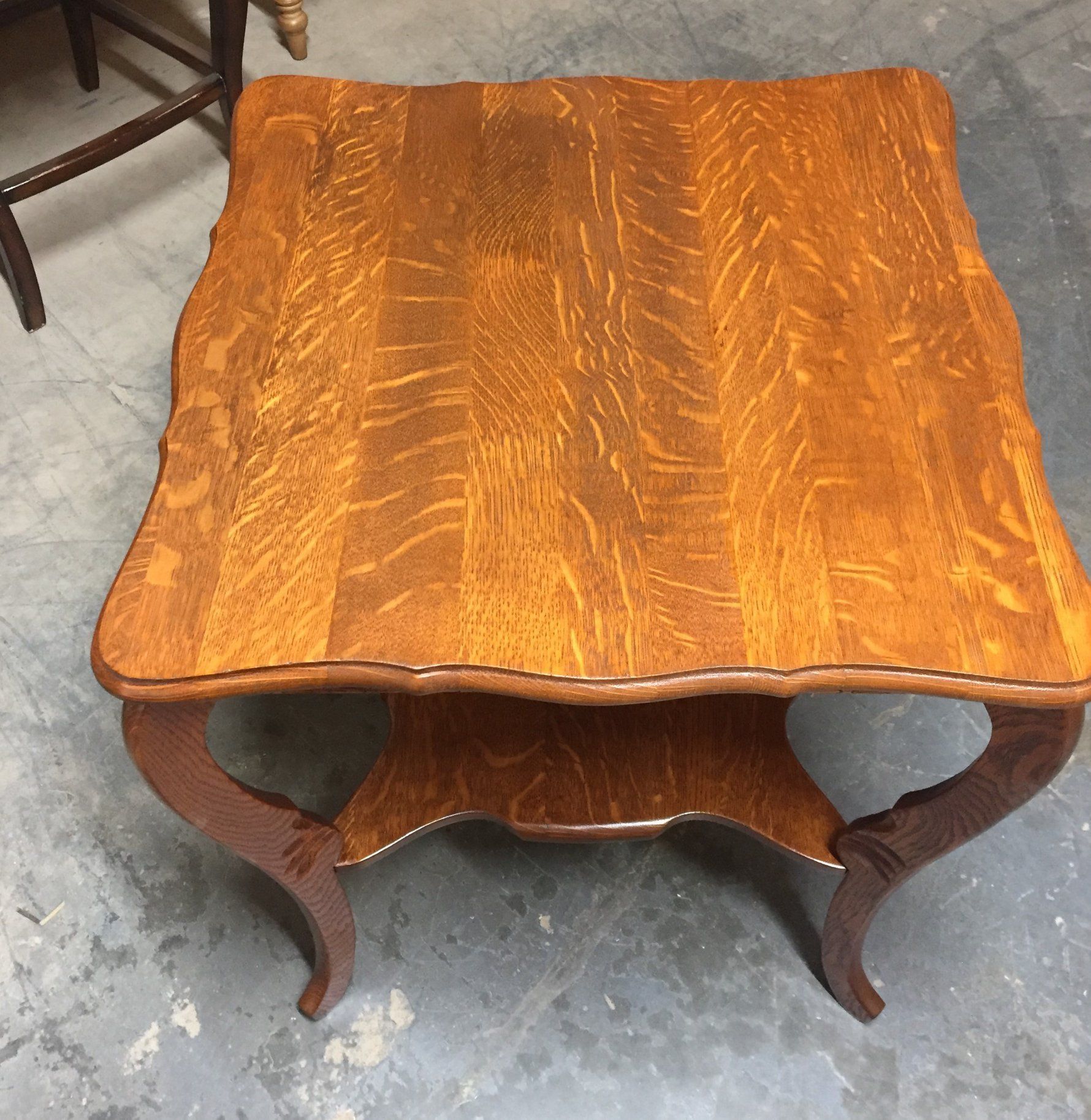 a wooden table with a shelf underneath it