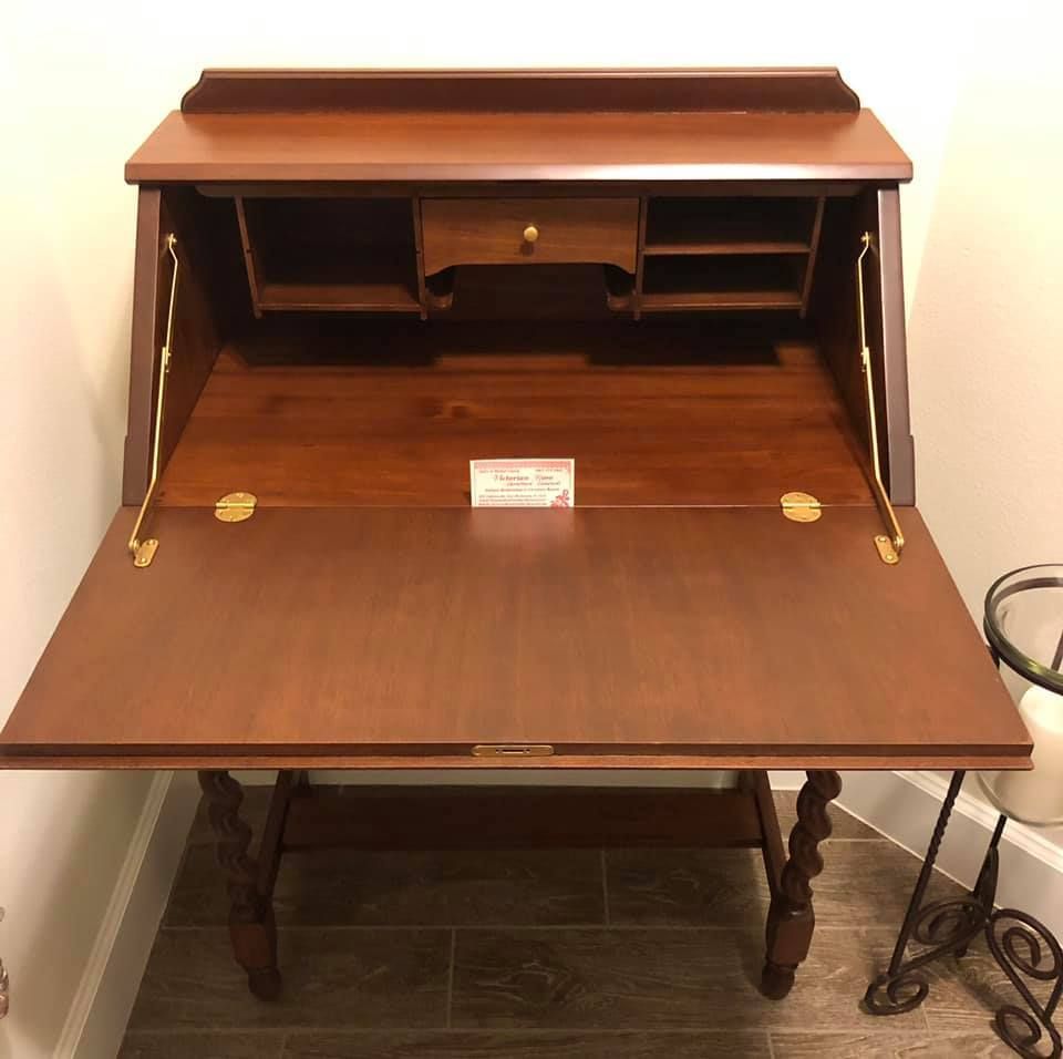 a small wooden desk with the lid open