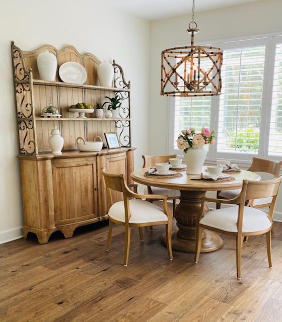 a dining room with a round table and chairs