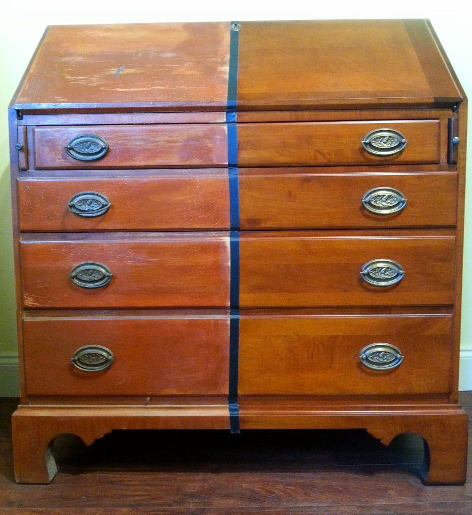 a wooden chest of drawers with brass handles