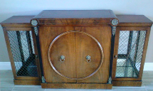 a wooden cabinet with a circle on the door is sitting on a tiled floor