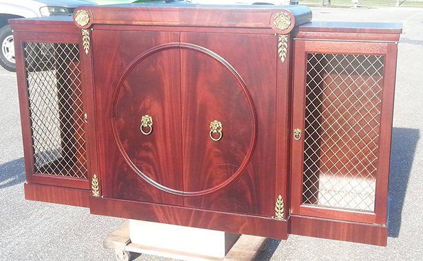 a wooden cabinet with a circle in the middle of it