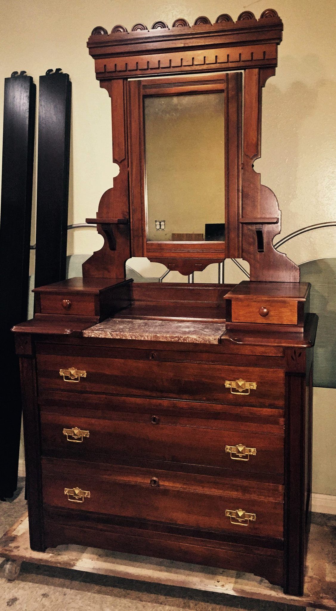 a wooden dresser with a mirror on top of it