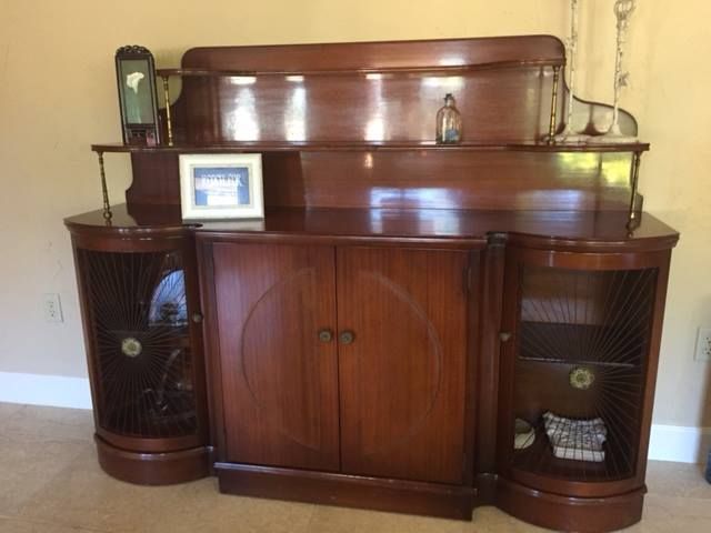 a wooden cabinet with a picture on top of it