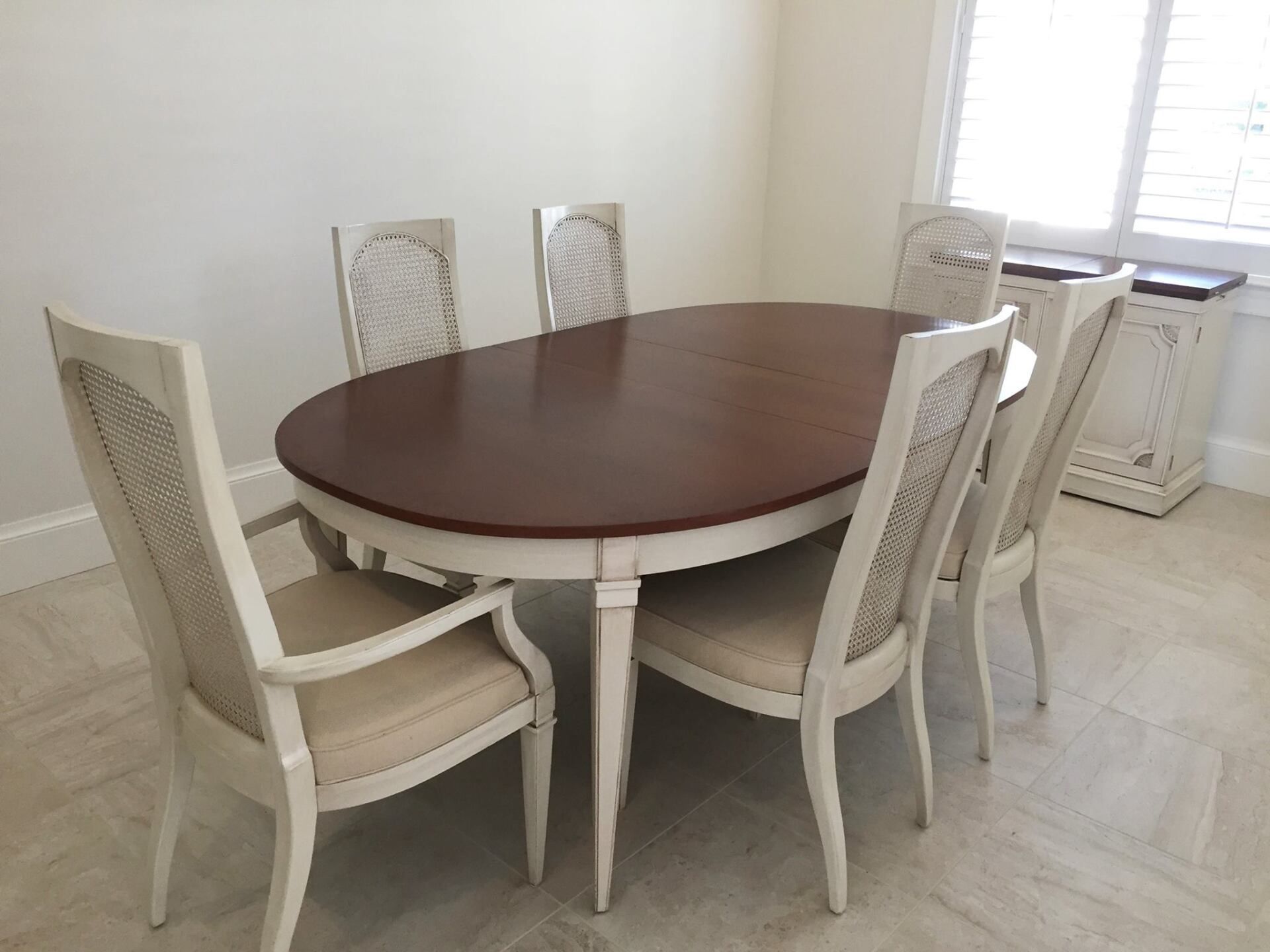 a dining room table and chairs in a room with a window