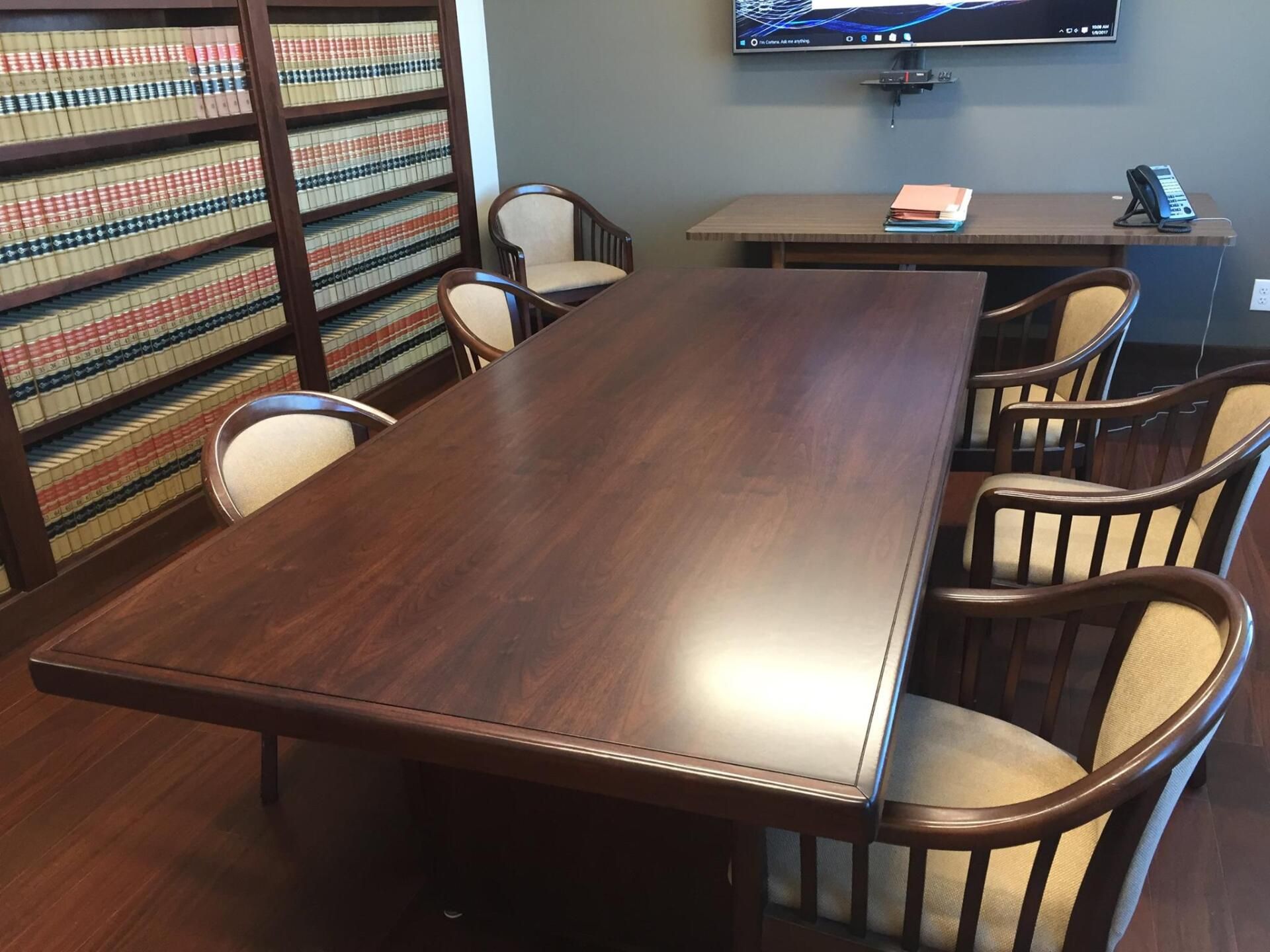 a conference room with a long wooden table and chairs
