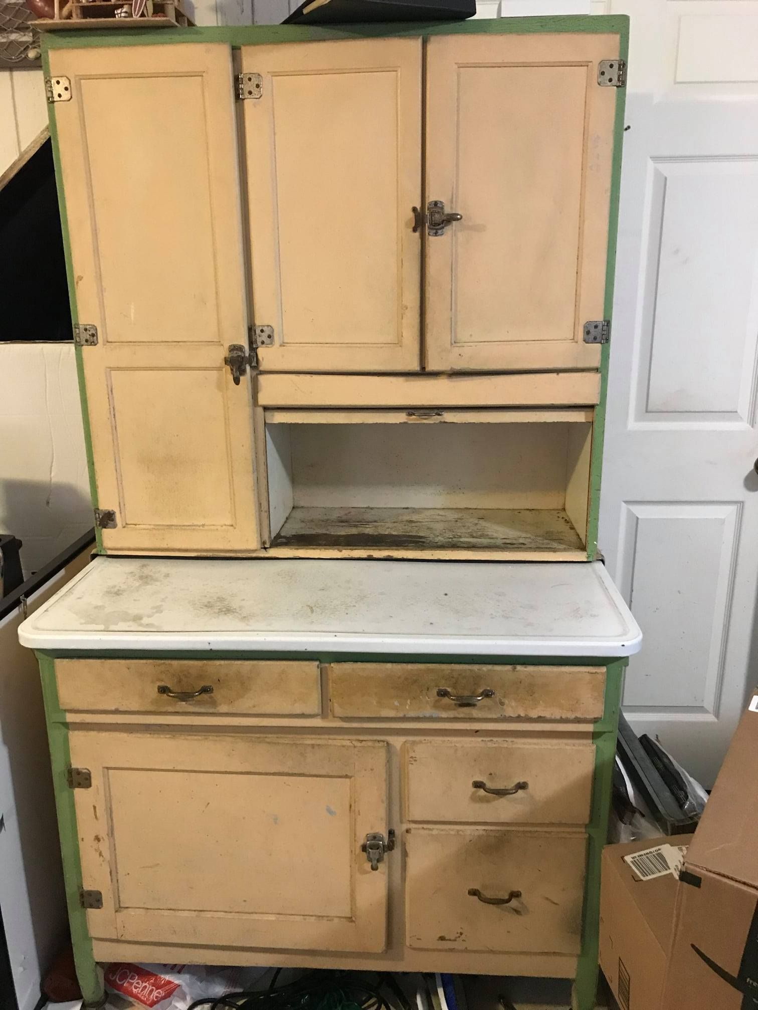 a wooden cabinet with drawers and doors