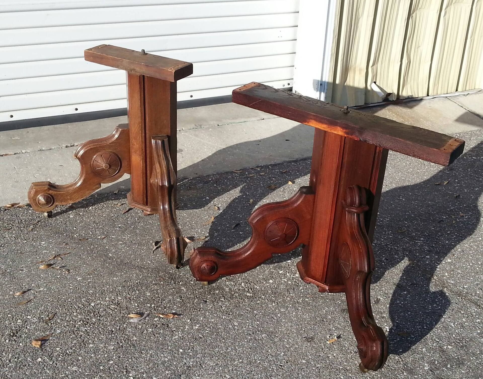 a pair of wooden table legs are sitting on the ground