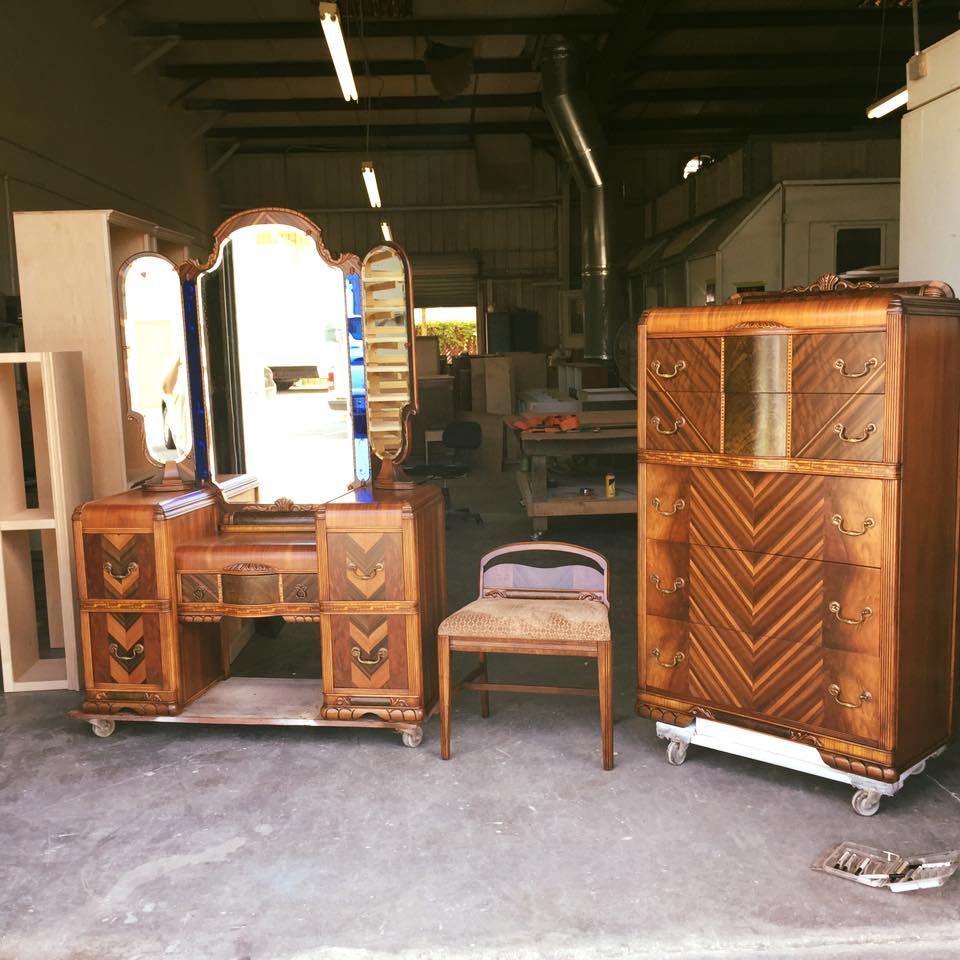 a dresser with a mirror and a chair in a room