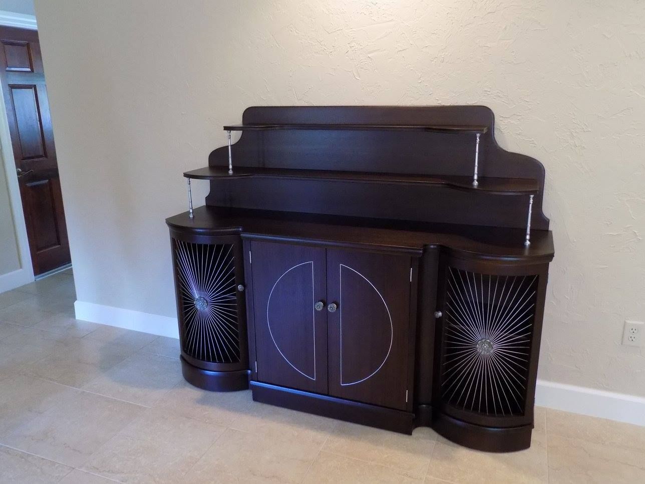 a dark wooden cabinet with a star design on it