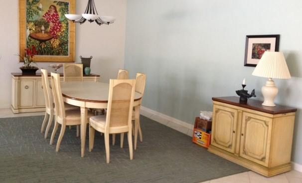 a dining room with a table and chairs and a lamp