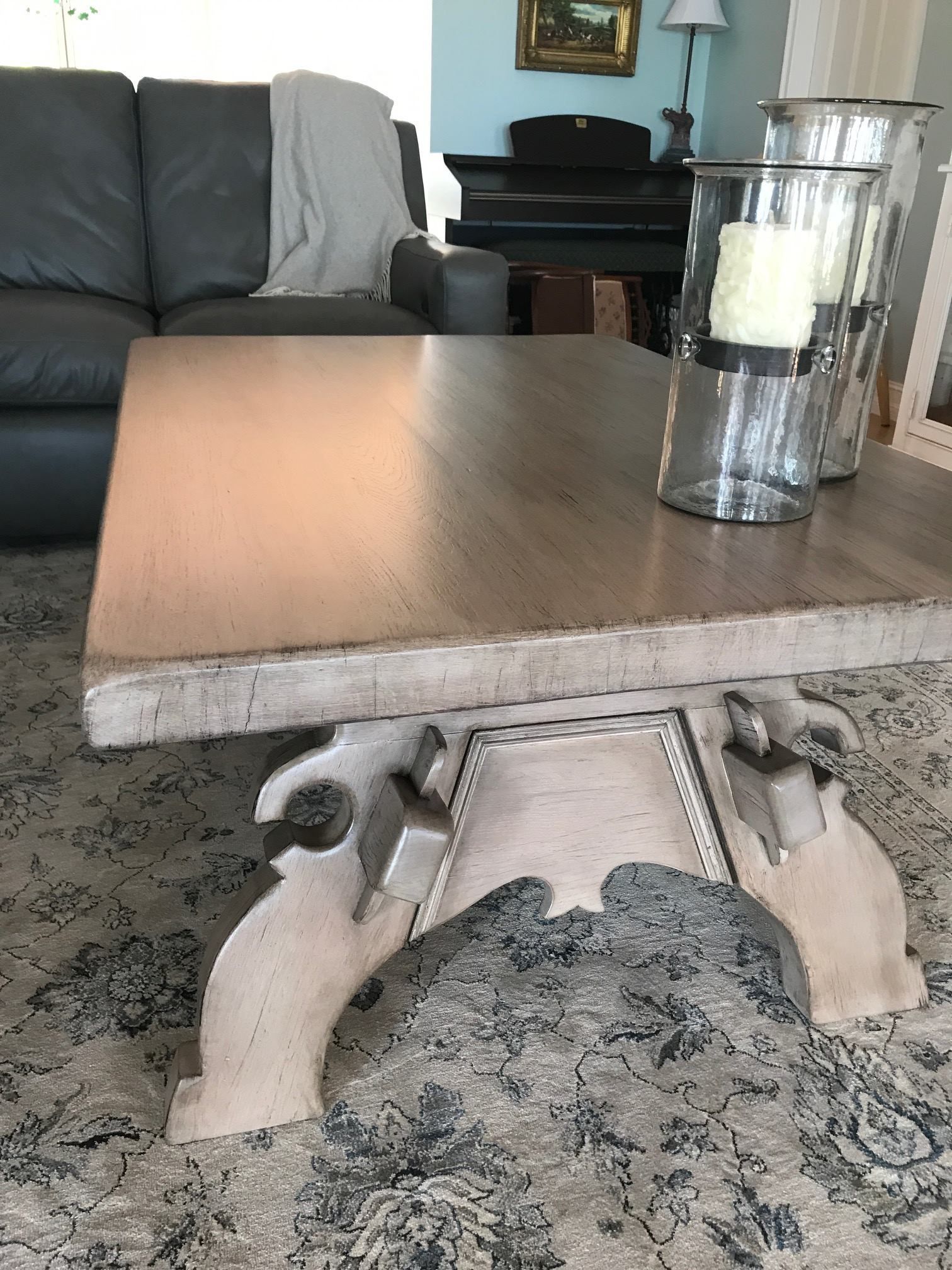a coffee table with candles on it in a living room