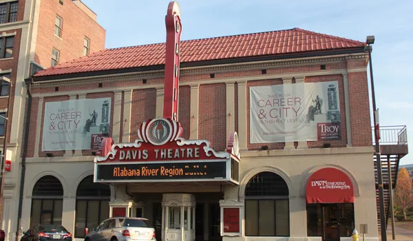 Davis Theatre, a historic brick building with a red marquee. Includes a sign that says 