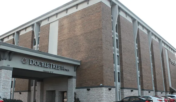 DoubleTree by Hilton hotel exterior, brick building, overcast sky.