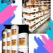 Paint cans stacked in store, with additional paint cans, and boxes of paint.