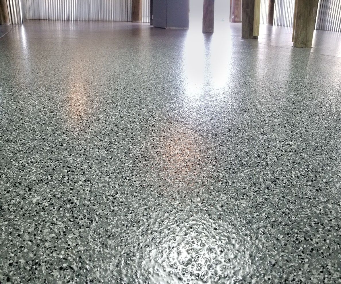 A close up of a shiny epoxy flooring in a room.