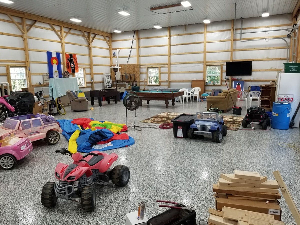 A garage filled with lots of toys and a pool table.