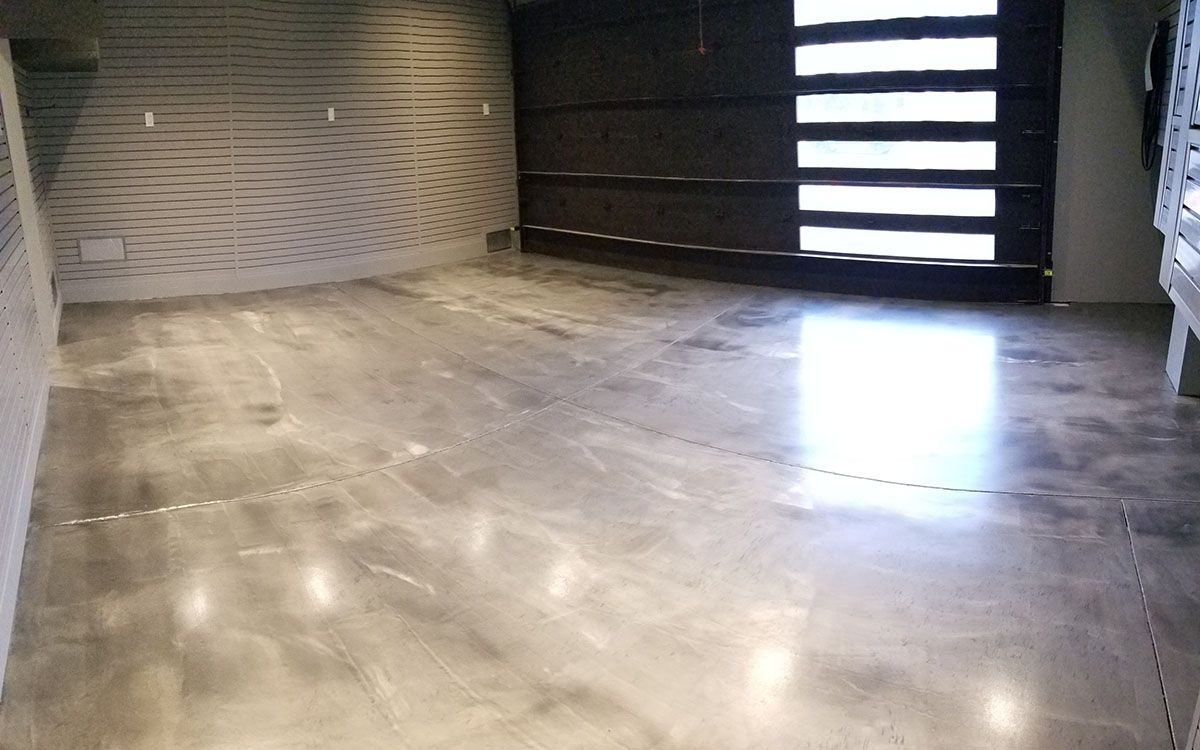 A garage with a concrete floor and a sliding garage door.