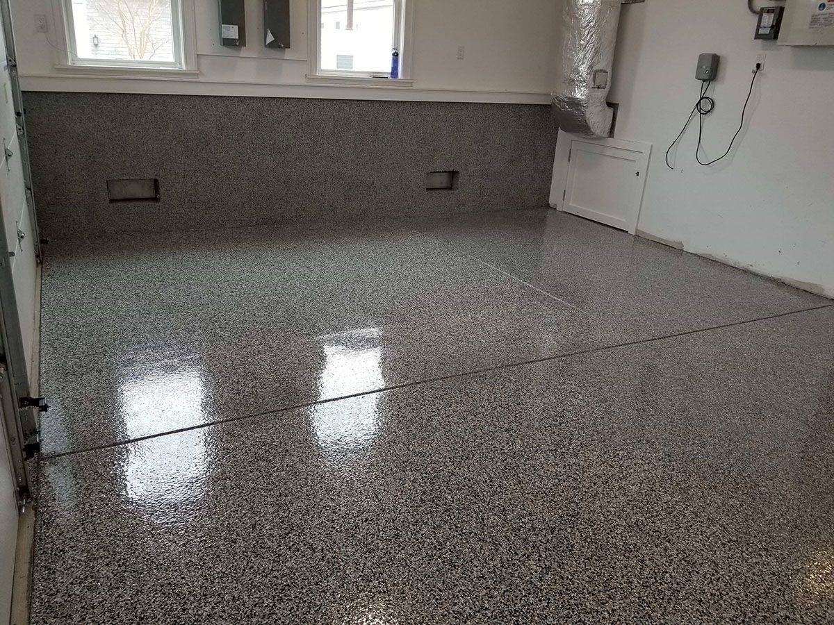 A garage with a shiny floor and a white wall.