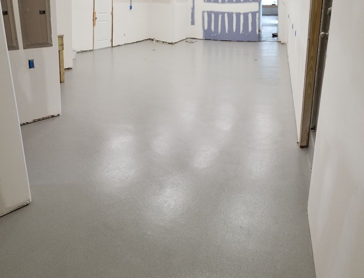 A large room with a gray floor and white walls.