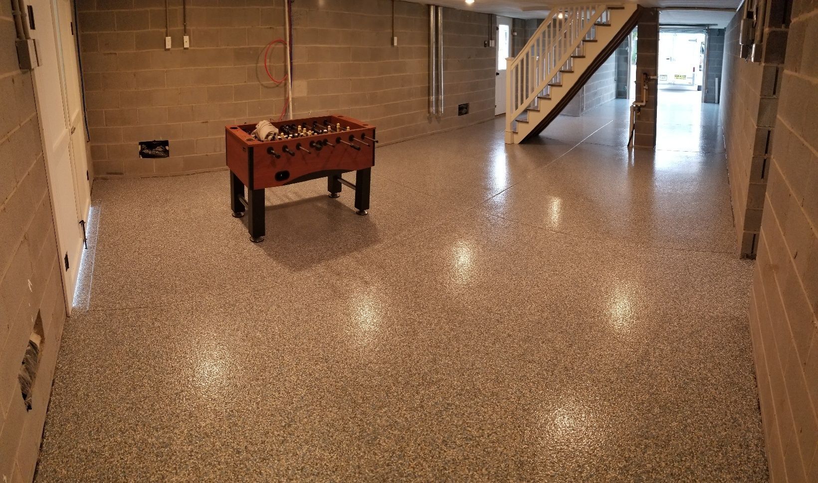 There is a foosball table in the middle of the room.