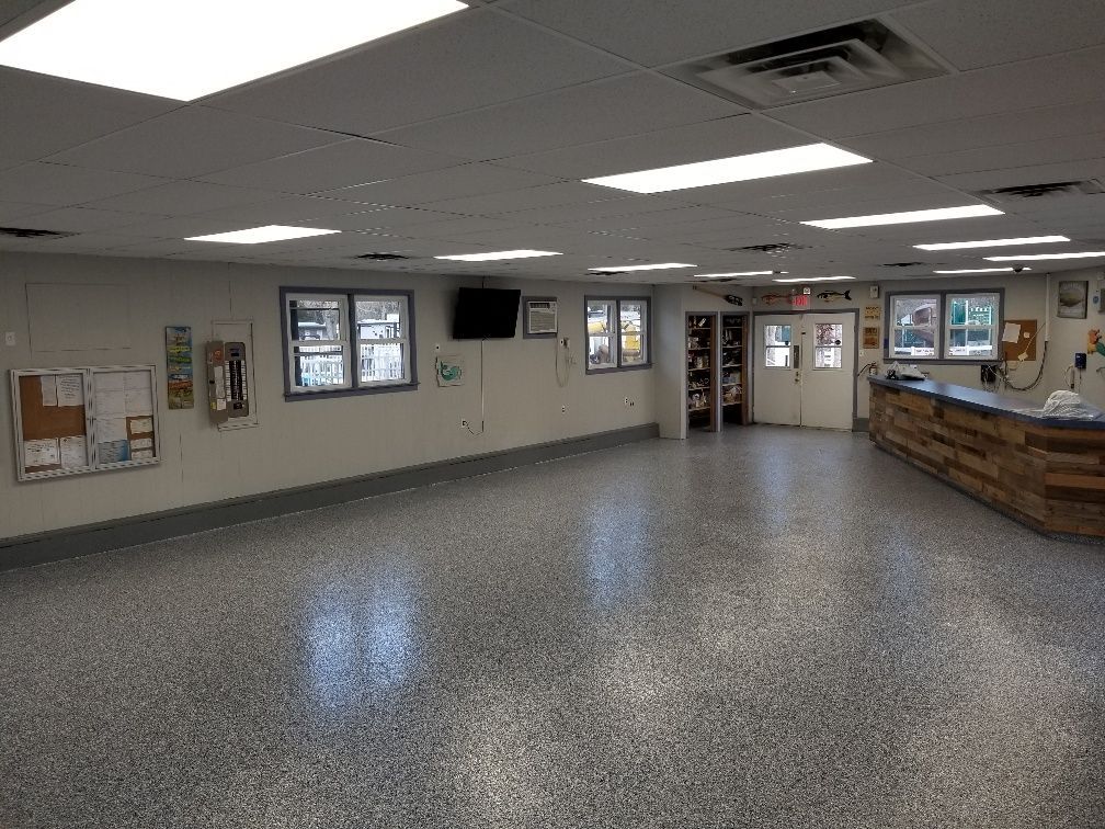 A large empty room with a counter and a lot of windows.