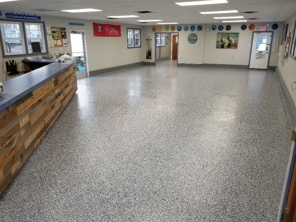 A large room with a coca cola sign on the wall.