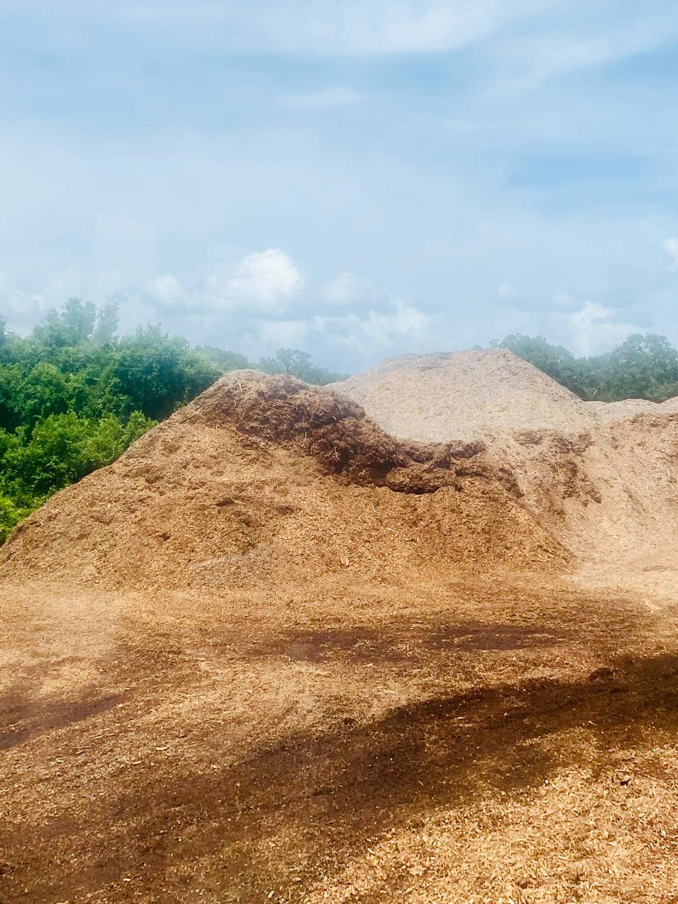 A large pile of dirt is sitting on top of a dirt field.