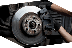 Auto technician repairing car brake