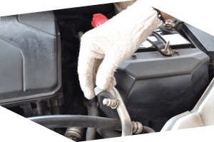 Auto mechanic repairing engine wiring